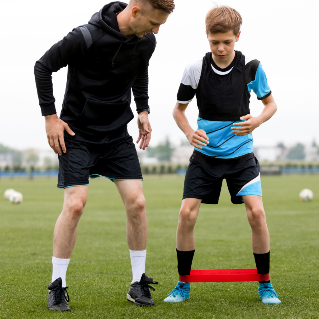 Soccer coach trains youth athlete wearing high end performance equipment.
